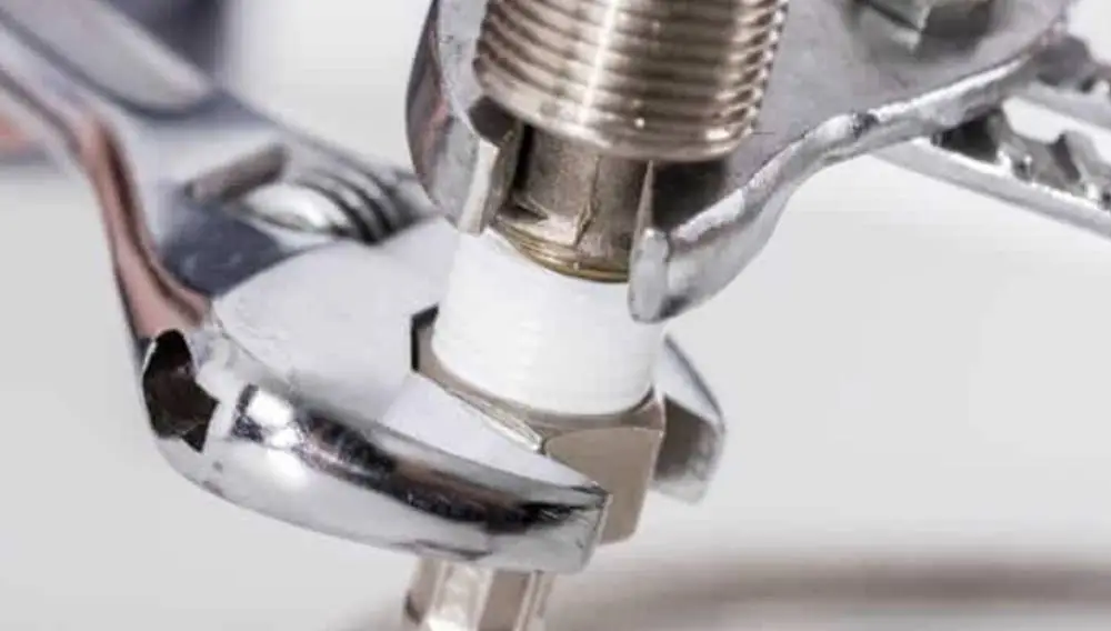 Wrenches tightening a fitting